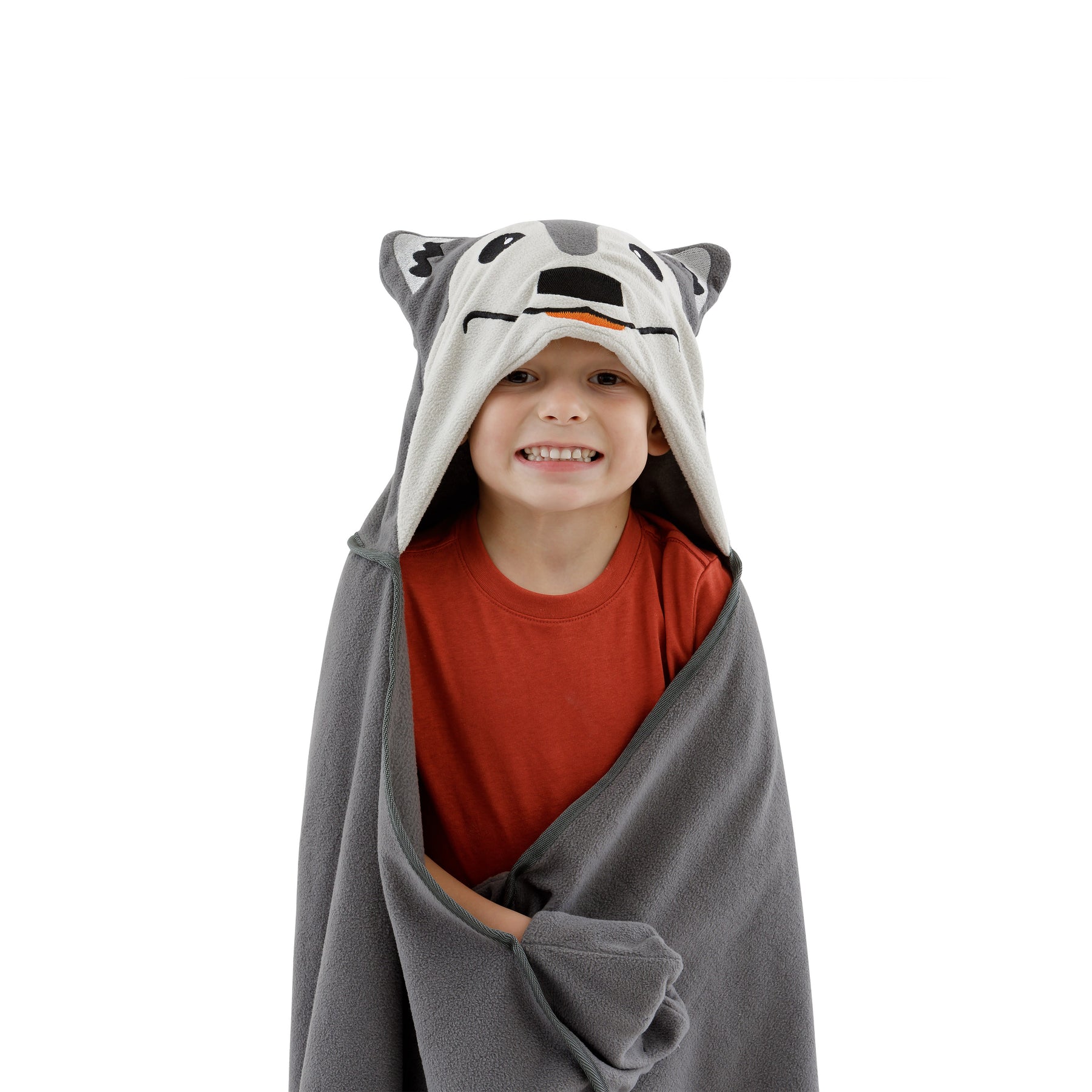 Child wearing a Aspen the wolf hooded blanket and smiling on a white background